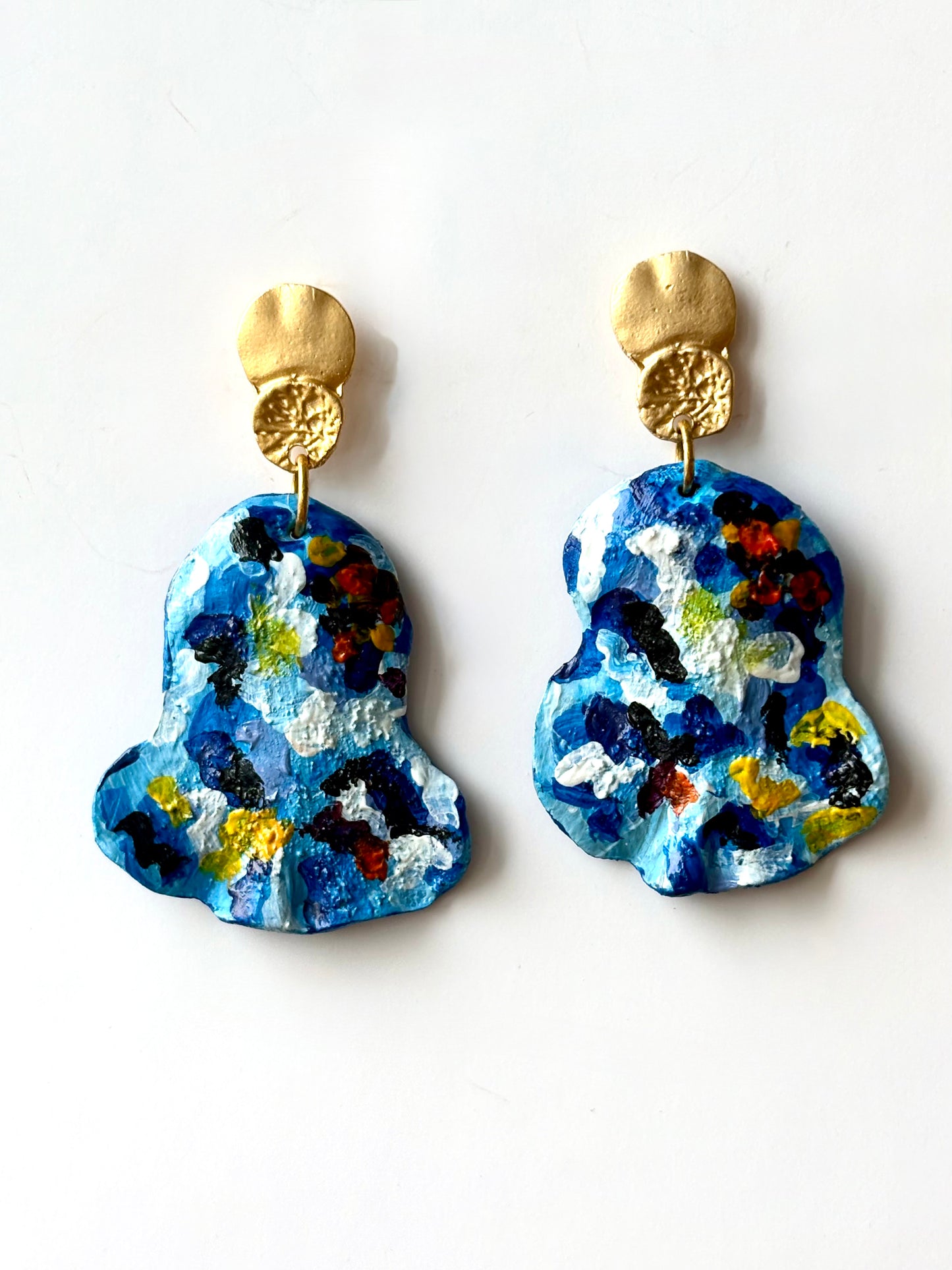 Handmade and hand-painted blue mosaic drop earrings with gold metallic tops on a white background